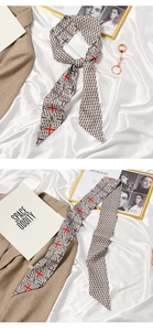 Detailed view of long French silk scarf with vintage geometric prints on white silk cloth