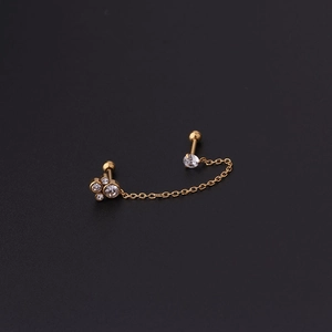 Detail showing 16G gold chain ear bone studs with sparkling cubic zirconia and ball backings