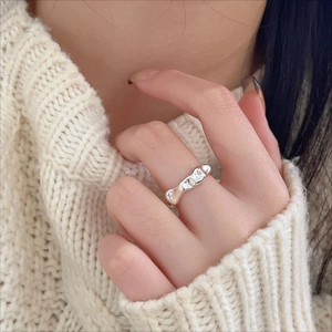 Close-up of irregular textured 925 sterling silver ring with liquid metal design