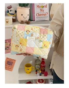 Gros plan d'une trousse à maquillage matelassée aux motifs de dessins animés colorés
