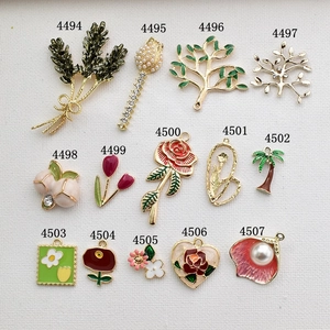 Assorted gold alloy botanical charms with enamel and pearls for DIY jewelry making