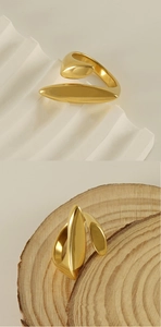 Detail of 18k gold geometric ring featuring artistic irregular curves and metallic luster