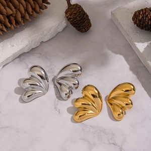 Polished butterfly wing stud earrings in 18K gold and silver plating on marble base