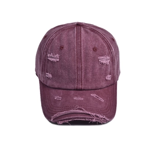 Distressed dark purple washed cotton baseball cap with ripped holes and curved brim