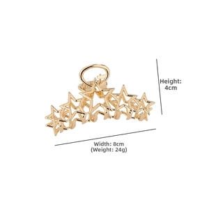 Detail view of a gold star hair claw clip with dimensions 8cm wide and 4cm high
