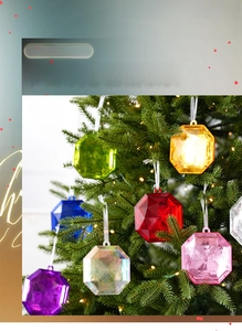Close-up of colorful octagonal gem ornaments hanging on a decorated Christmas tree