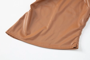 Detailed close-up of brown PU leather hem featuring fine stitching and smooth grain texture