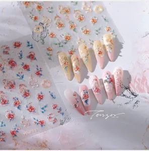 Detail of floral and golden snake embossed nail art stickers with frosted 3D texture