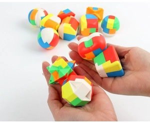 Detailed close-up of colorful plastic interlocking puzzles held in hands on white background