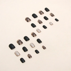 Short square press-on nails with black, silver glitter, and translucent polka dot patterns
