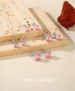 Close-up of S925 silver pink morganite round stud earrings on a textured stone