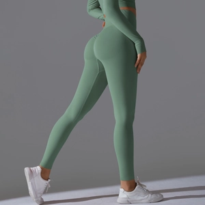 Detail of high-waist seamless scrunch butt yoga pants and long sleeve crop top in green