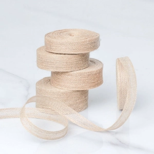 Natural jute twine rolls for gift wrapping and DIY crafts on white marble background