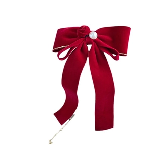 Elegant red velvet bow hair clip with faux pearl and gold tassel fringes on white background