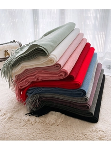 Close-up of soft cashmere-feel scarves with fringe details in various gradient colors