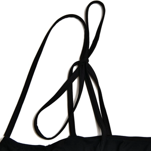 Detailed close-up of thin adjustable knotted shoulder straps on a black off-shoulder dress