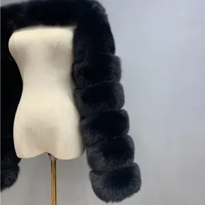 Detail of black faux fox fur coat showing the horizontal tiered sleeve texture