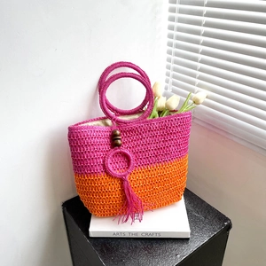 Fuchsia and orange straw tote bag with round wooden handles for summer beach vacations