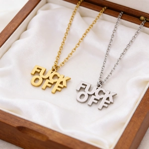 Edgy punk style gold and silver Fuck Off letter pendant necklaces on silk background