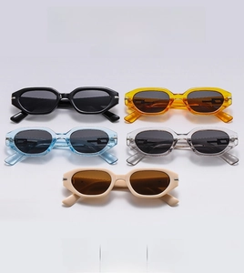 Flat lay of retro rectangle sunglasses in various colors on white background