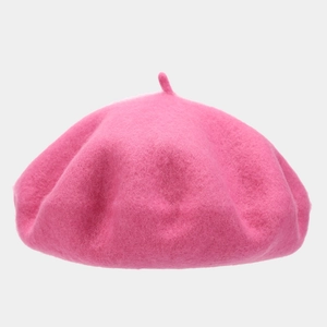 Detailed texture of thick rose pink wool beret with a classic small stem top design