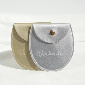 Detail of silver and gold PU leather jewelry pouches with metallic snap buttons