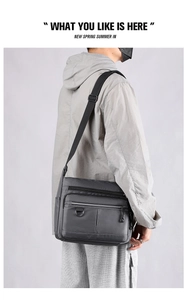Side view of dark grey waterproof nylon crossbody bag worn on a casual male model