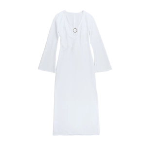 Detailed close-up of V-neck white knit dress featuring silver metal ring accent