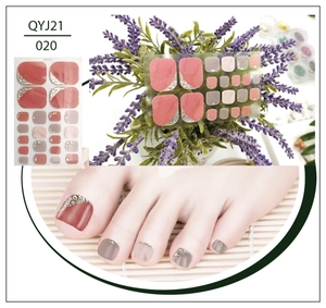 Detail of pink and grey glitter toenail wraps with rhinestones and lavender decor