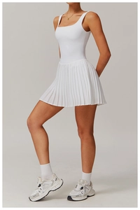 Detail view of white tennis dress with pleated skirt and high-waisted design for sports