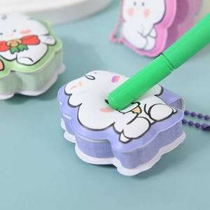 Cute cartoon puppy stress relief notebooks in pastel colors with green marker for scale
