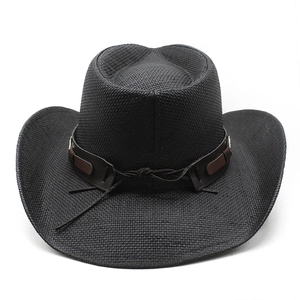 Close-up of black straw cowboy hat featuring brown leather band and metallic buckle detail