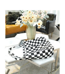 Detailed view of black and white checkerboard tote bag on marble table setting