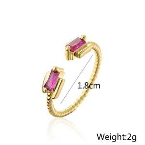 Detail view of gold-plated twisted ring with pink rectangular zircons and size specs