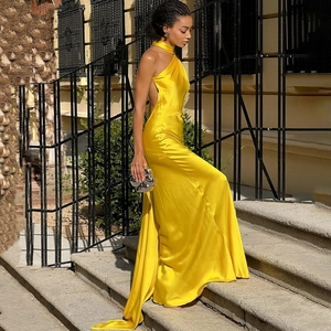 Elegant yellow satin backless halter neck long dress with a sleek flowing silhouette