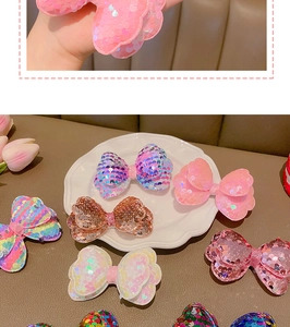 Detail of glittery sequin bow hair clips in various colors for girls and toddlers