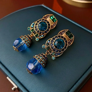 Vintage style gold earrings with deep blue crystal and emerald green accents
