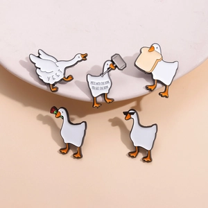 Set of five funny white swan enamel pins with creative animal motifs on a pink background