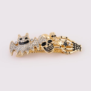 Gothic Halloween hair clip featuring rhinestone bat, skull and star in antique gold finish