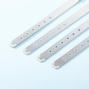 Detailed view of silver mesh watch bands with adjustable buckles on a light blue background