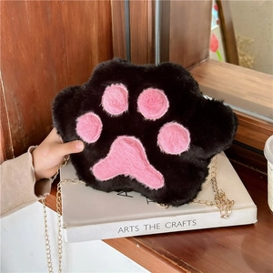 Detail of plush cat paw shoulder bag with soft black faux fur and pink claw pads
