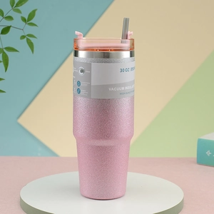 Detail of 30oz pink glitter vacuum insulated tumbler with straw and packaging specs