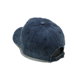 Adjustable metal buckle strap on distressed navy blue washed denim baseball cap