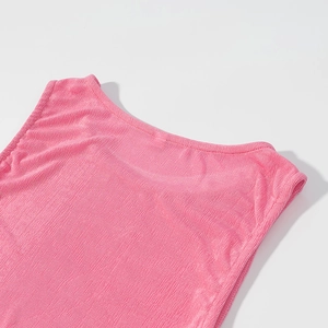 Detail of pink knit dress showing ribbed texture and collar stitching on white background