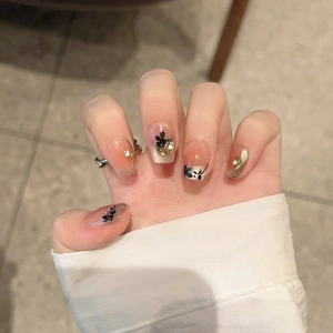 Elegant gold foil maple leaf press-on nails with butterfly patterns and orange gradients