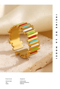 Detailed macro shot of a gold open ring featuring vibrant colorful enamel inlay work