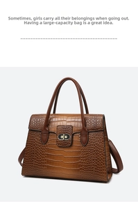 Detail view of the brown stone pattern leather bag featuring a gold metal twist lock