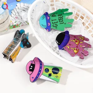 Detail of UFO acrylic hair claw clip with colorful GET IN LOSER text and metal spring