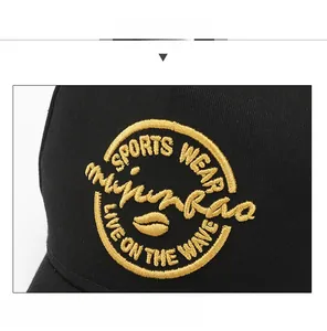 Close-up of golden embroidery logo on a black five-panel baseball cap for men