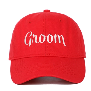 Red baseball cap with white embroidered Groom text for wedding party celebrations